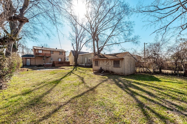 view of yard with an outdoor structure and a shed