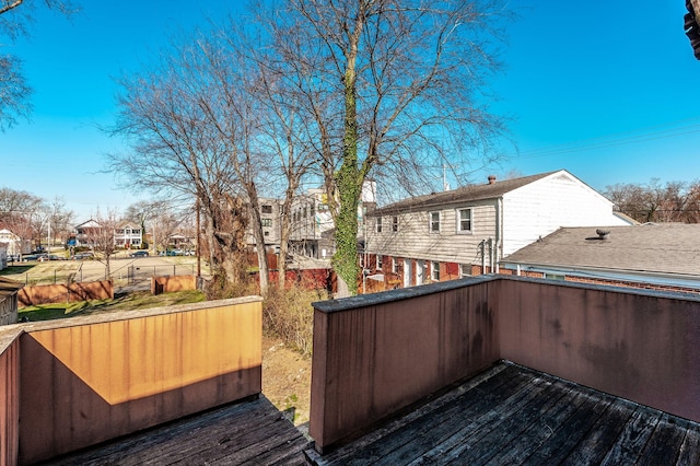 exterior space featuring a residential view and fence