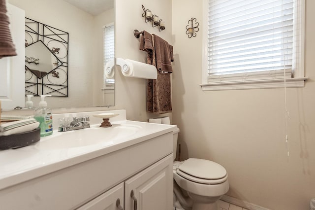 half bath featuring baseboards, toilet, and vanity