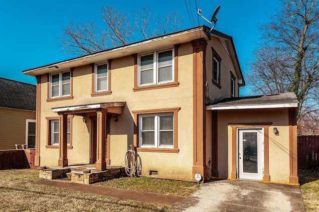 view of front of property featuring crawl space, stucco siding, and fence