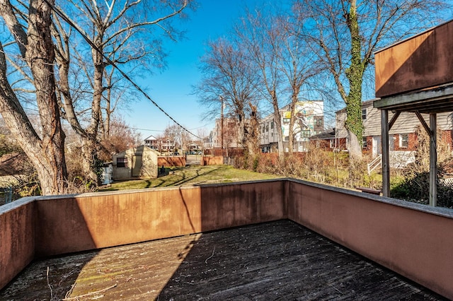 exterior space featuring an outbuilding, fence, and a residential view