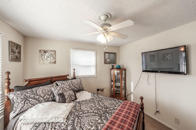 bedroom with baseboards, a textured ceiling, ceiling fan, and carpet flooring