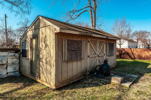 view of shed featuring fence