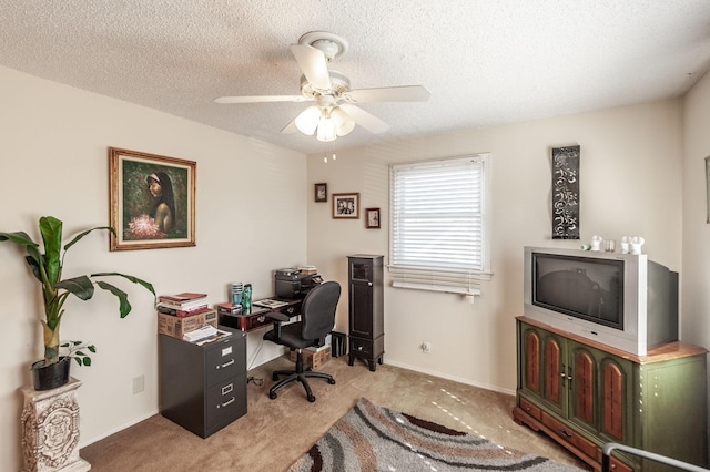 home office featuring baseboards, light colored carpet, ceiling fan, and a textured ceiling