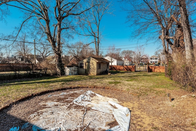 view of yard featuring an outdoor structure and fence