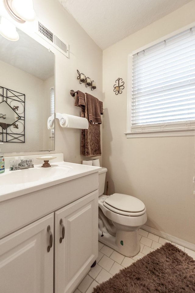 bathroom with tile patterned floors, visible vents, toilet, and vanity