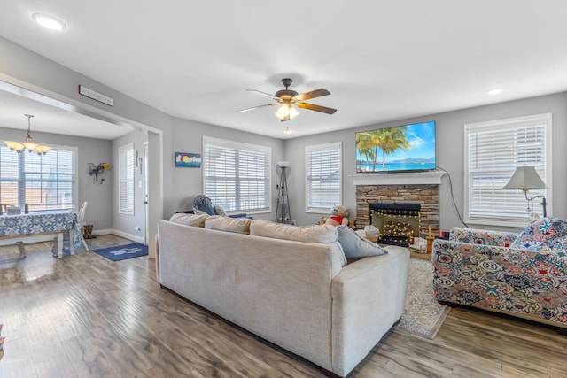 living area featuring wood finished floors, baseboards, and a healthy amount of sunlight