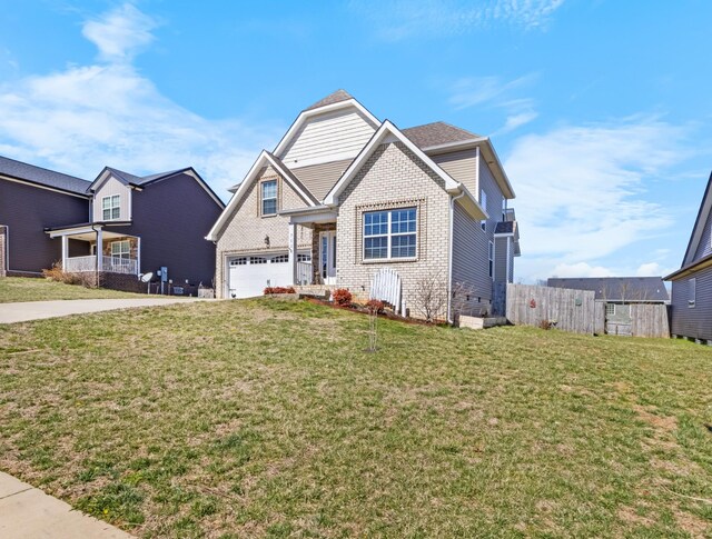 view of front of property with brick siding, driveway, a front lawn, and fence