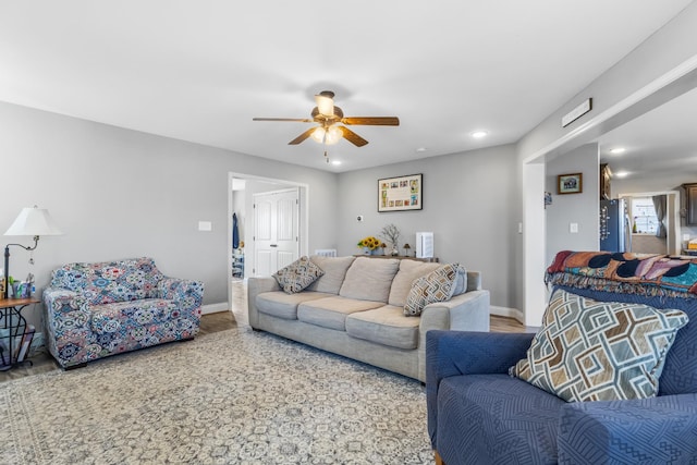 living room featuring recessed lighting, ceiling fan, and baseboards