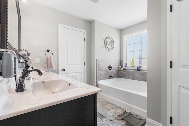 full bathroom featuring a sink, a bath, and double vanity