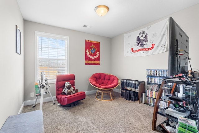 living area with visible vents, baseboards, and carpet flooring