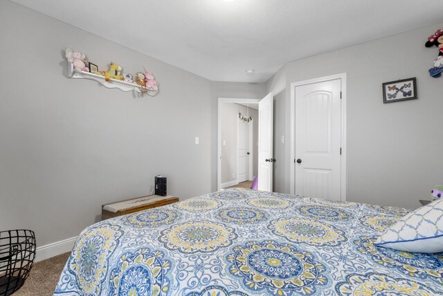 bedroom featuring carpet and baseboards