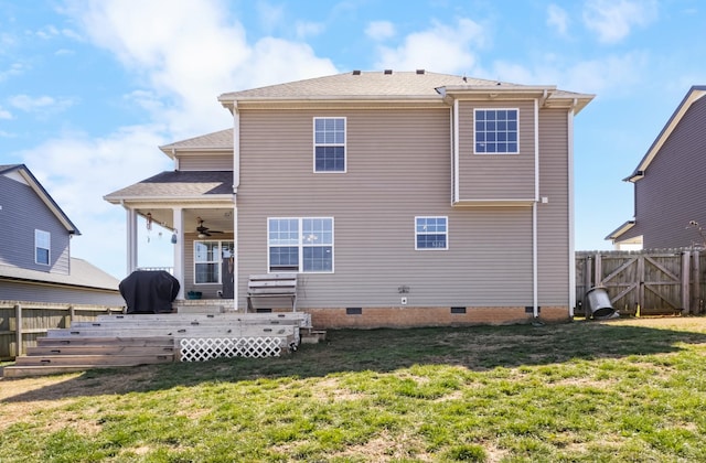 back of house with ceiling fan, fence, a lawn, a deck, and crawl space