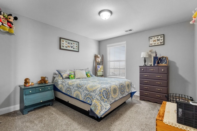 bedroom with visible vents, carpet floors, and baseboards