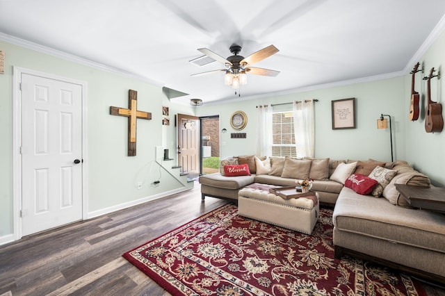 living area featuring ceiling fan, crown molding, baseboards, and wood finished floors