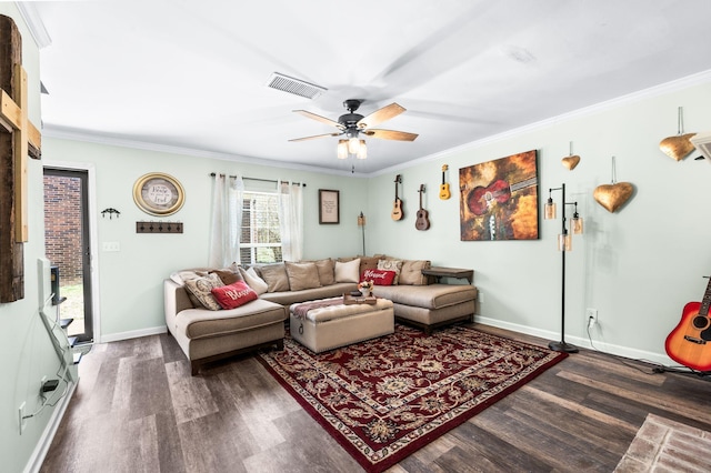 living room with baseboards, wood finished floors, visible vents, and ornamental molding