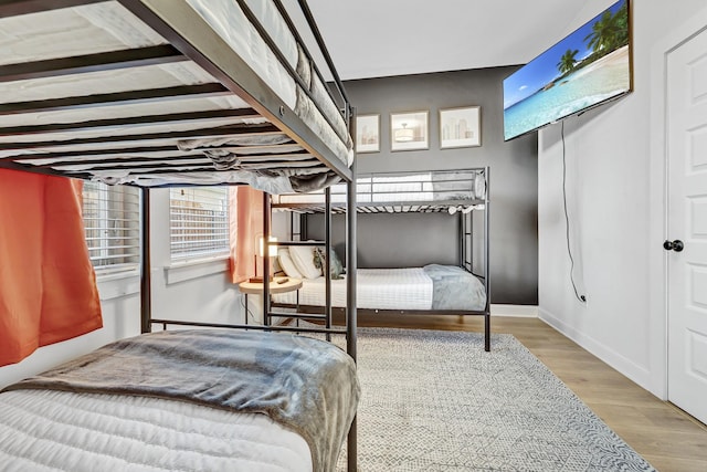 bedroom featuring wood finished floors and baseboards