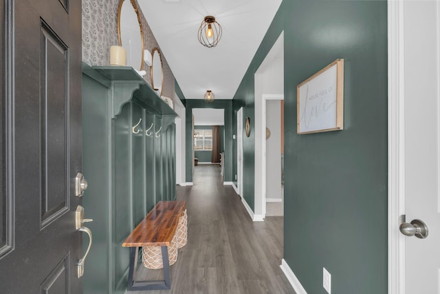 interior space with baseboards and wood finished floors