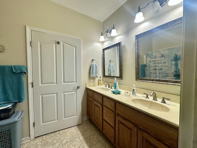 bathroom featuring double vanity, tile patterned floors, and a sink