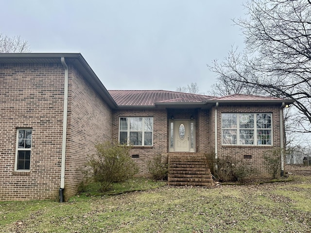 view of front of property featuring crawl space and brick siding