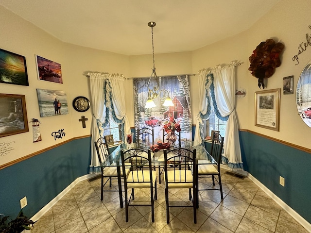 dining space with visible vents, baseboards, a notable chandelier, and tile patterned flooring