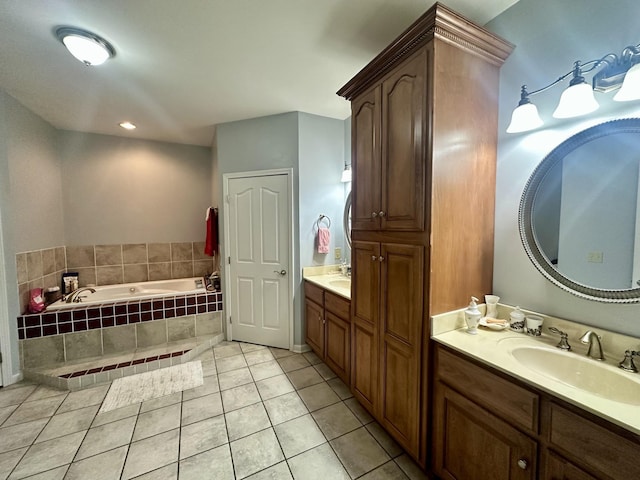 bathroom with tile patterned floors, a garden tub, and vanity