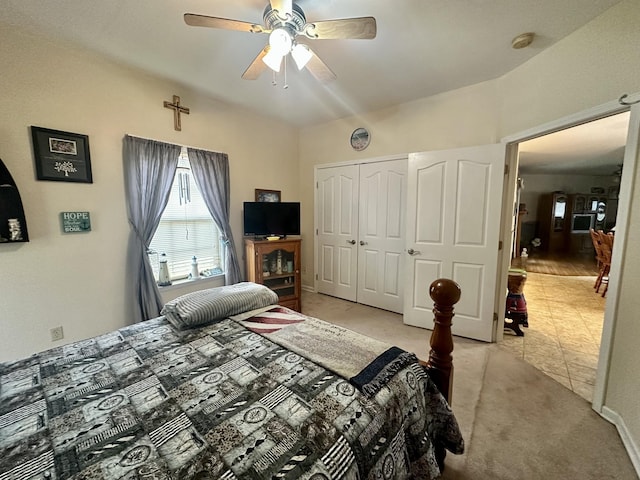 bedroom featuring light carpet, ceiling fan, and a closet