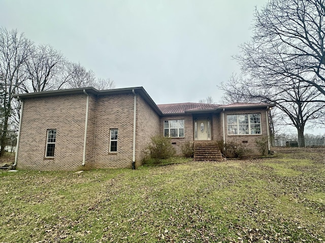 view of front of home featuring a front lawn, brick siding, and crawl space