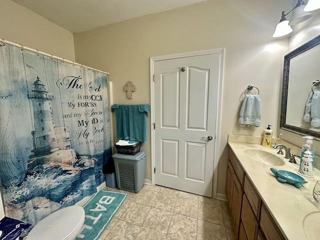 bathroom featuring toilet, vanity, and a shower with curtain