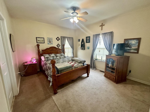 carpeted bedroom with baseboards and a ceiling fan