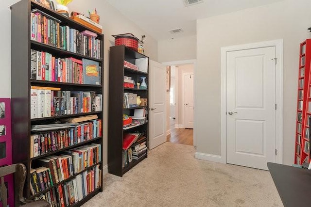 living area featuring carpet flooring and visible vents