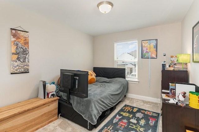 bedroom with baseboards and carpet