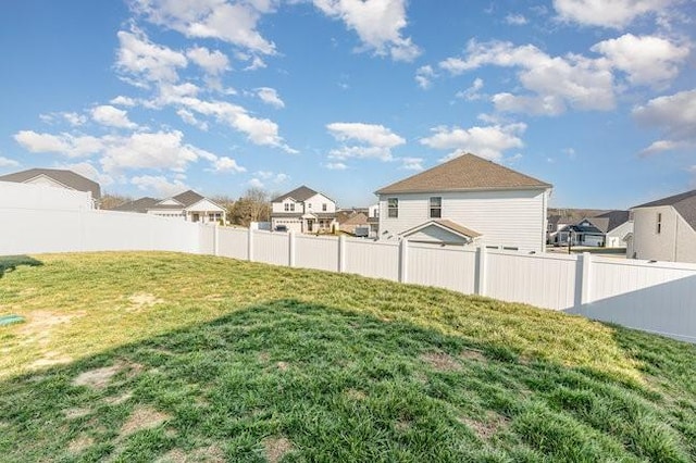 view of yard featuring a residential view and fence