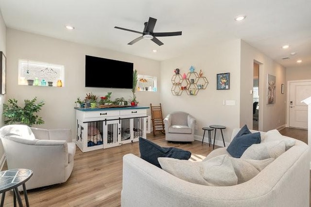 living room featuring recessed lighting, light wood-style flooring, and a ceiling fan