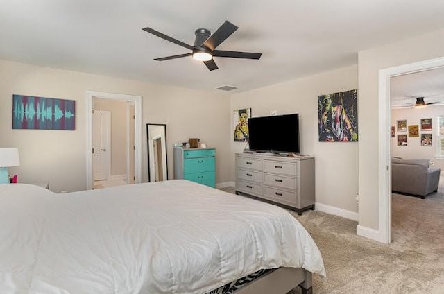 bedroom with a ceiling fan, light colored carpet, and baseboards