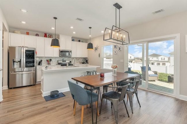 dining room with visible vents, recessed lighting, and light wood-style floors