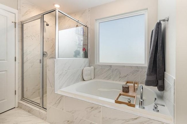 bathroom with a bath, a stall shower, and marble finish floor