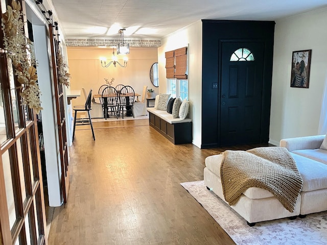 entrance foyer with a barn door and wood finished floors