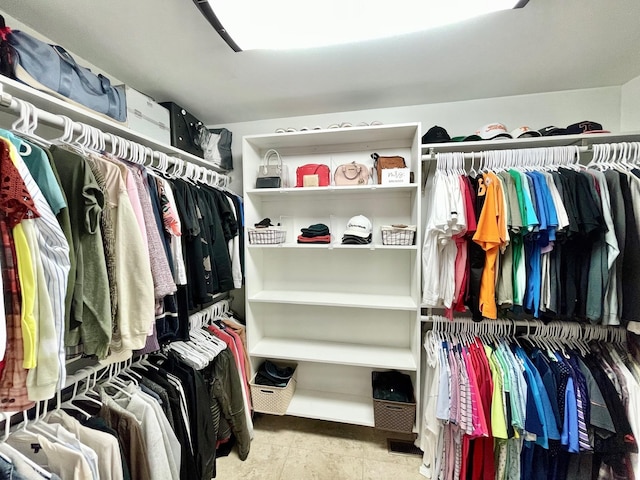 spacious closet with tile patterned floors