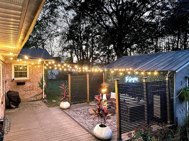 deck at twilight with grilling area