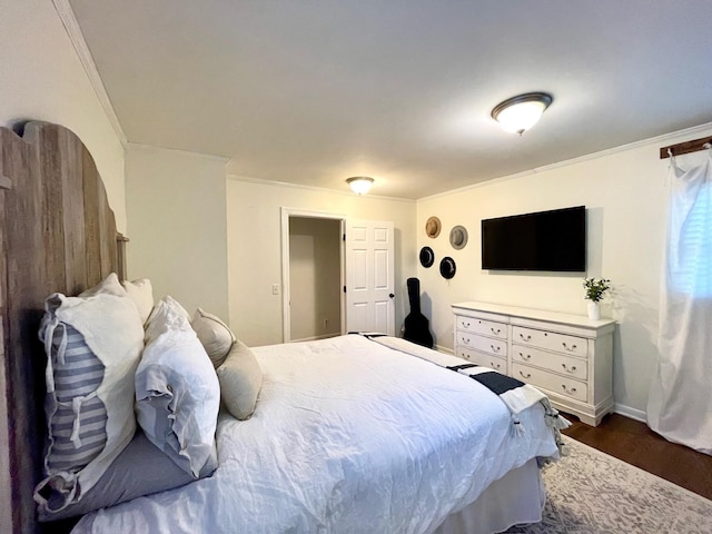 bedroom with dark wood-style floors and crown molding