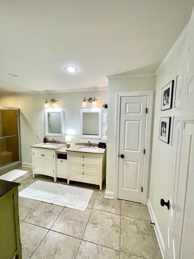 bathroom with baseboards, ornamental molding, and vanity