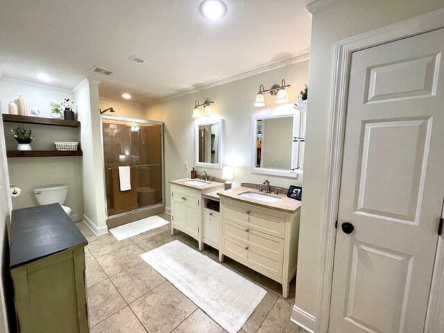 bathroom featuring a sink, toilet, a shower stall, and crown molding