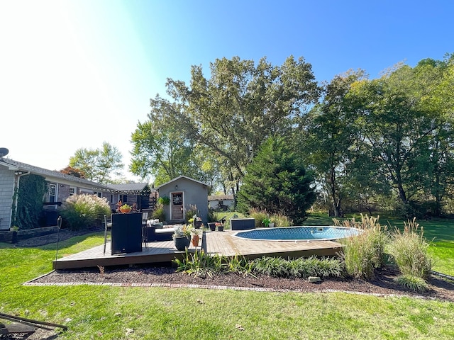 view of swimming pool featuring a yard and a deck