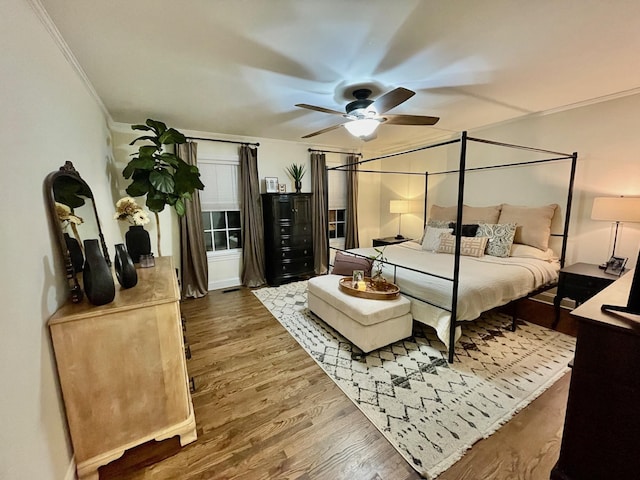 bedroom featuring ornamental molding, ceiling fan, and wood finished floors