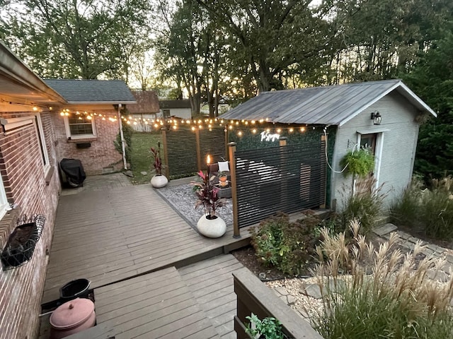 deck featuring an outbuilding and grilling area