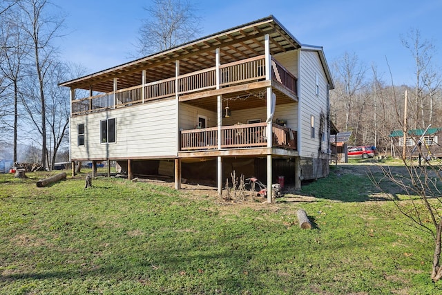 rear view of house featuring a yard