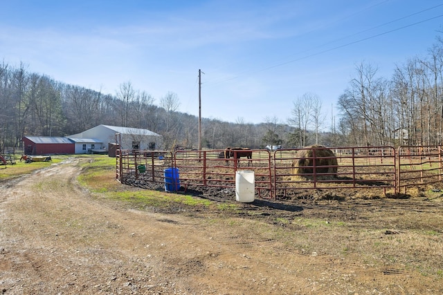 view of jungle gym featuring a rural view and a wooded view