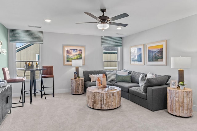 carpeted living area featuring recessed lighting, visible vents, baseboards, and ceiling fan