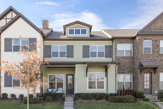 multi unit property featuring brick siding and roof with shingles